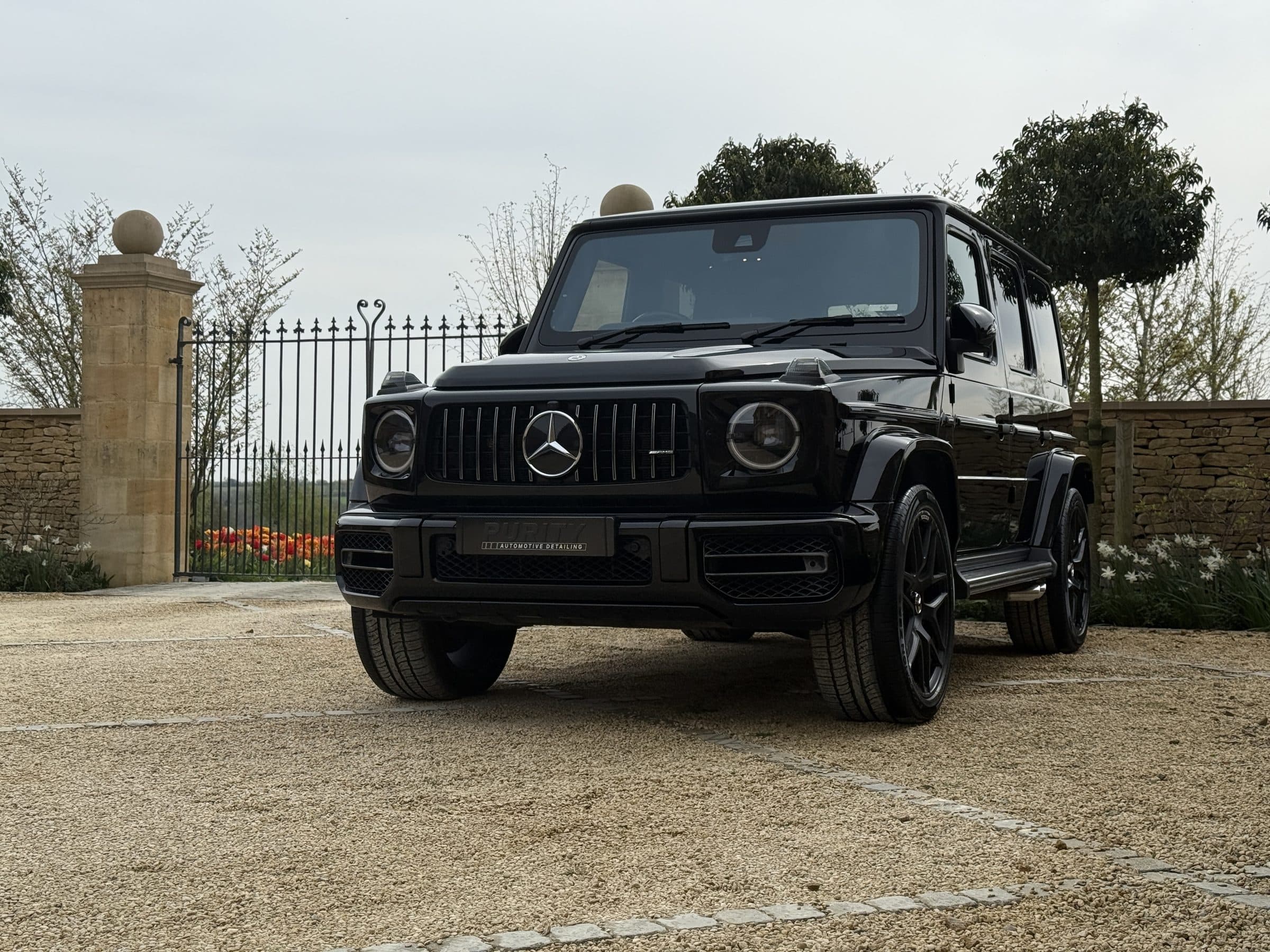 Black Mercedes-AMG G 63 by the gates of a country house