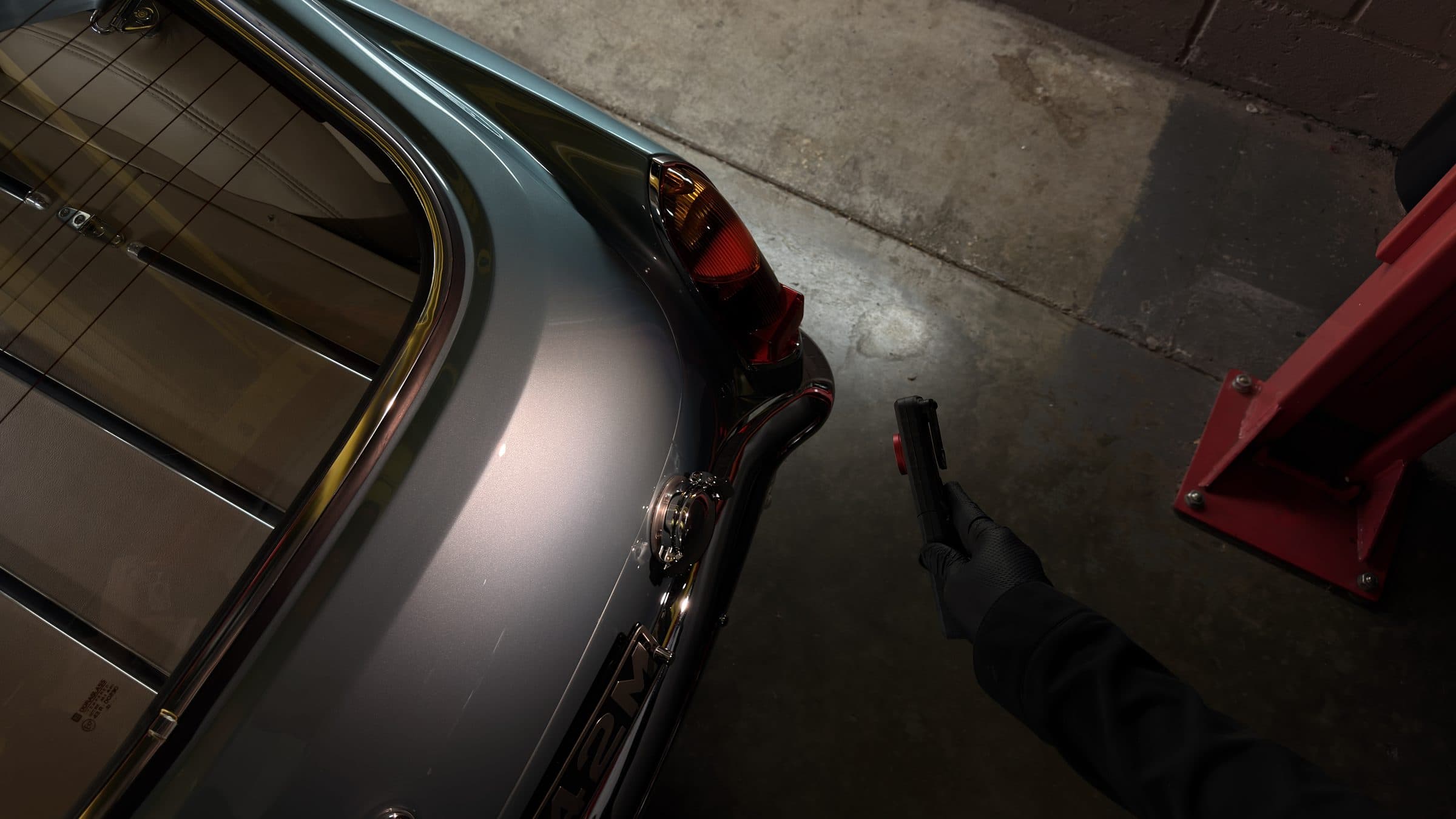 Inspection light checking the rear wing of a classic car